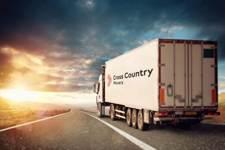A truck with Cross Country Movers logo on the road