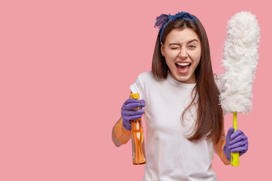 girl holding cleaning supplies