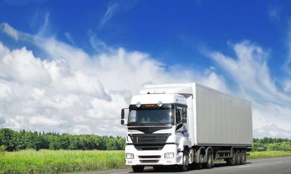 An image of a long-distance moving truck on the road