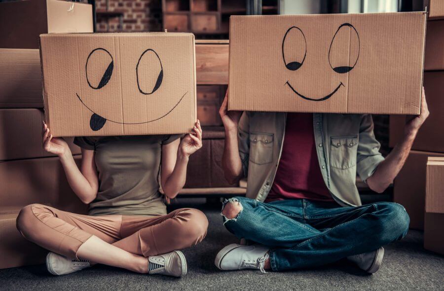 A couple with their heads covered with boxes