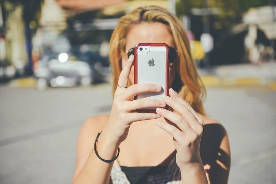 Girl holding a phone and taking a photo
