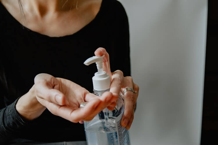 person using a hand sanitizer