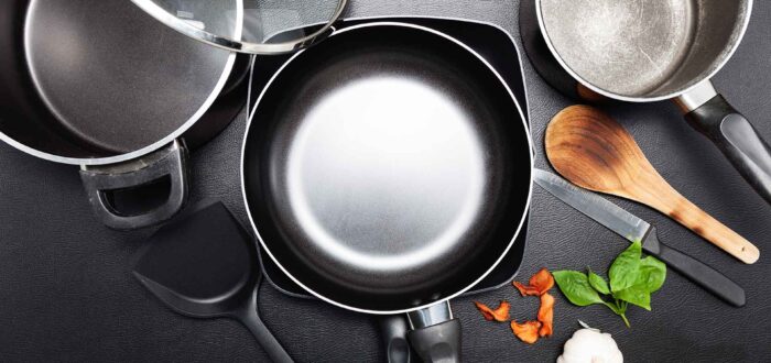 Top view frying pan and pot on black leather table image for cooking background and food design background