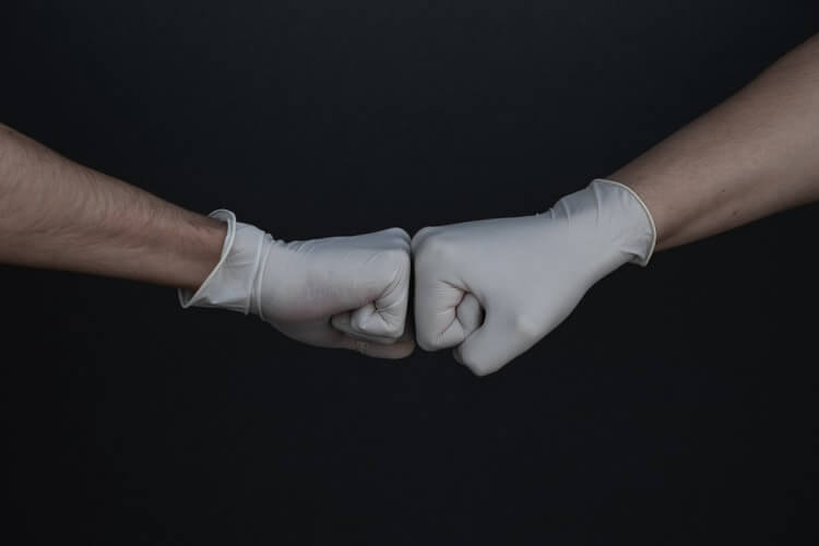 two fists in rubber gloves