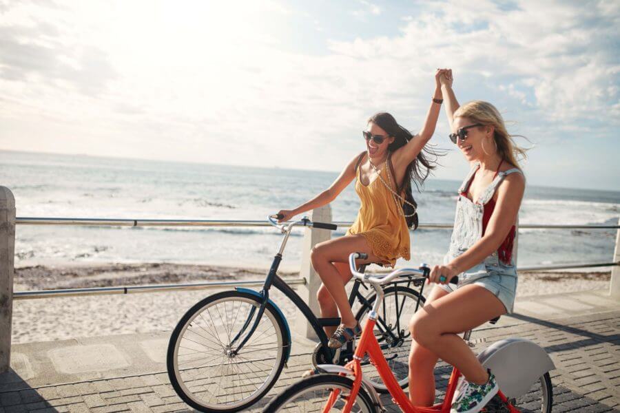 Girls biking on the beach