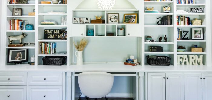 Indoor home office with desk and built in wood shelving