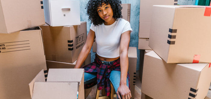 girl surrounded by boxes