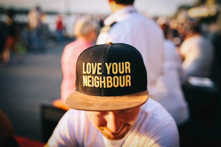 A hat with writing ''love your neighbor''