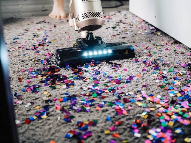 vacuuming confetti on the floor