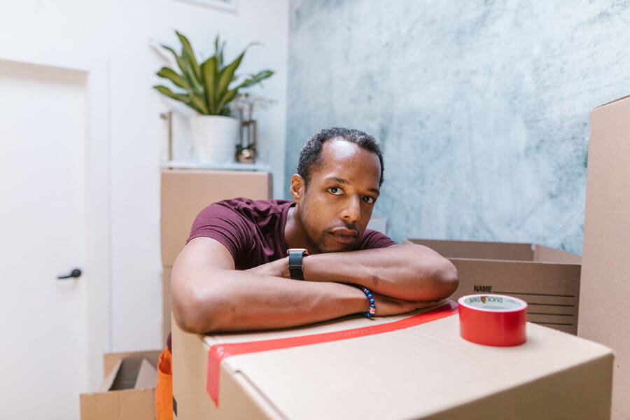 worried man preparing for long-distance moving