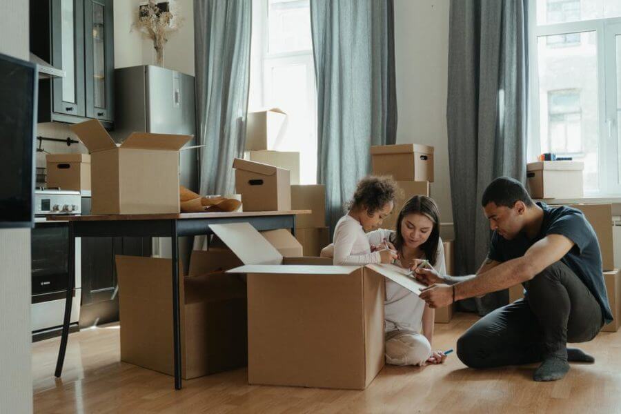 Family surrounded with long distance moving supplies