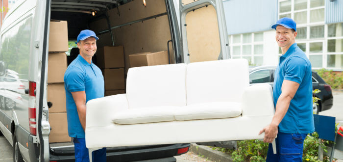 Cross-country movers carrying a couch