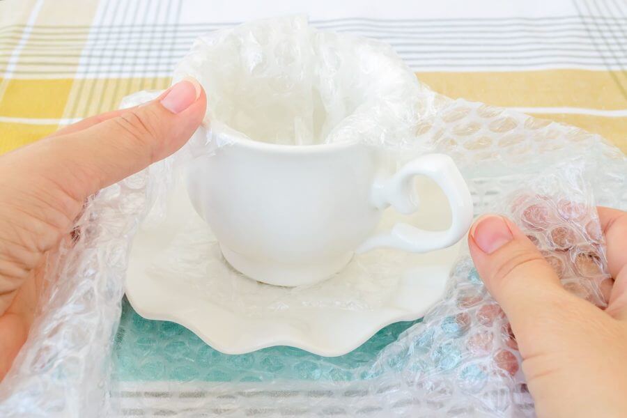 wrapped coffee mug in a bubble wrap for long-distance moving