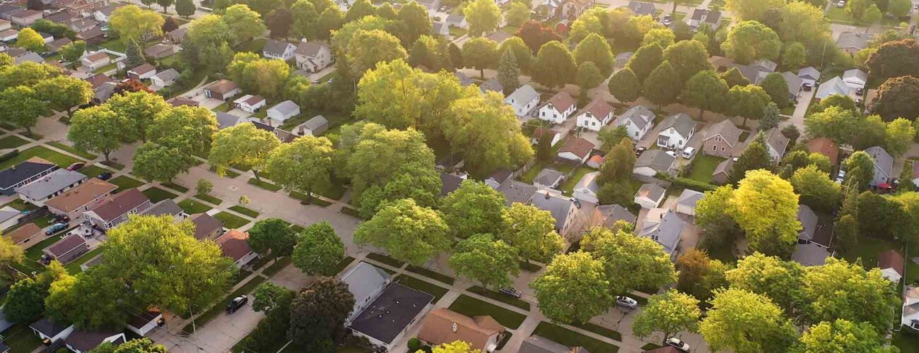 Aerial view of an American suburb in summertime. Establishing shot
