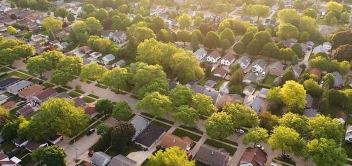 Aerial view of an American suburb in summertime. Establishing shot