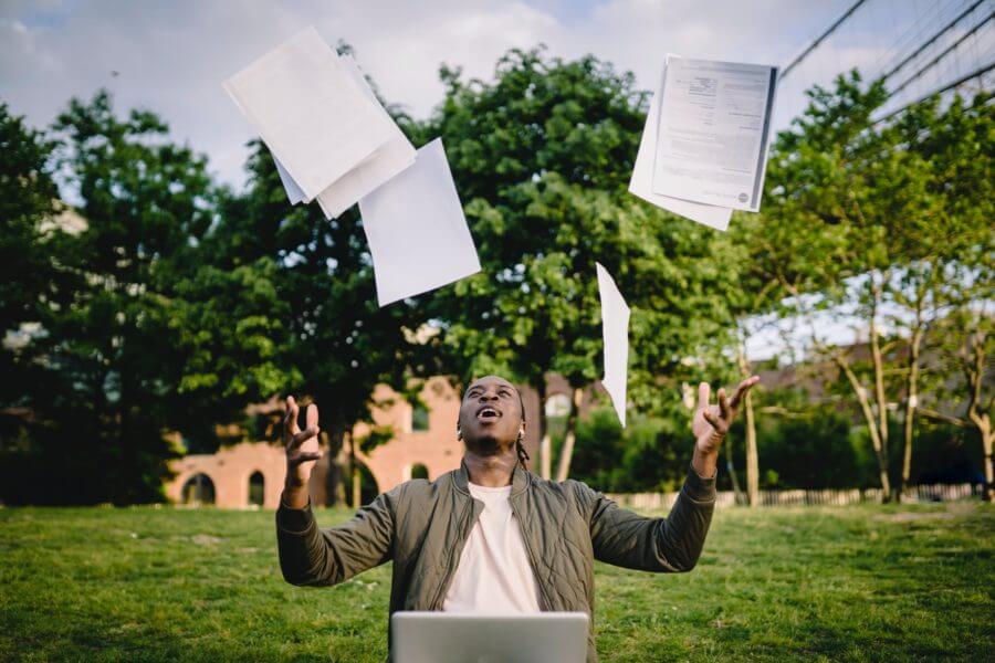 A graduate throwing papers