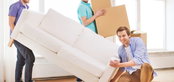 people packing a sofa and boxes for long-distance moving
