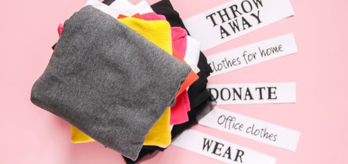 clothes with labels throw away, keep, wear, sell, give away, sorted for cross-country moving