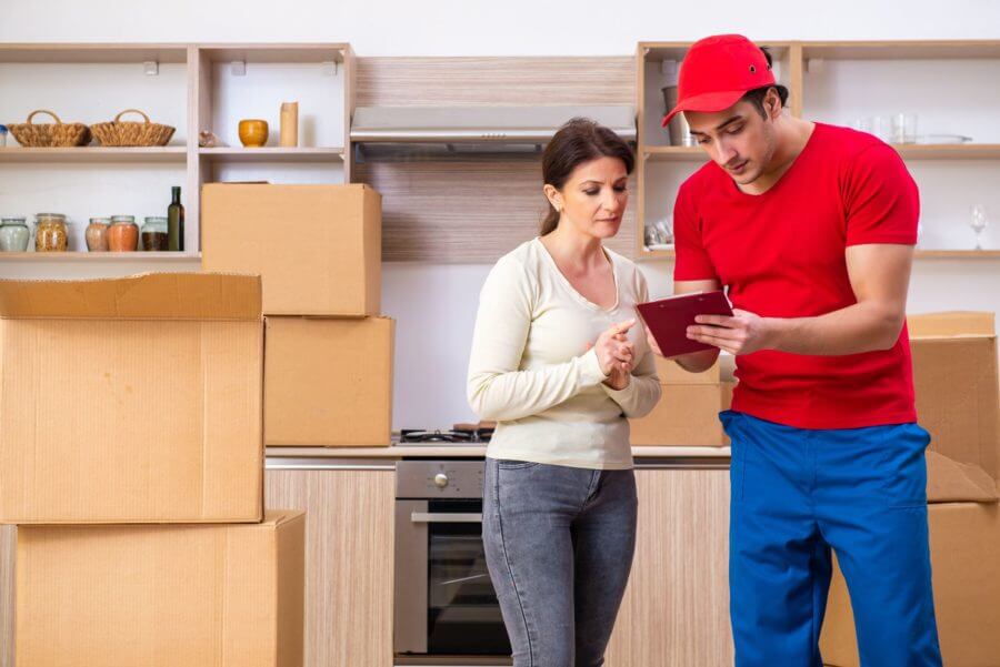 One of the long-distance movers showing a list to the woman 