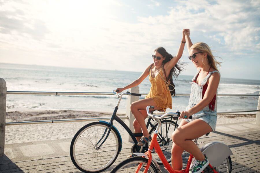 Two women riding bikes after moving cross country