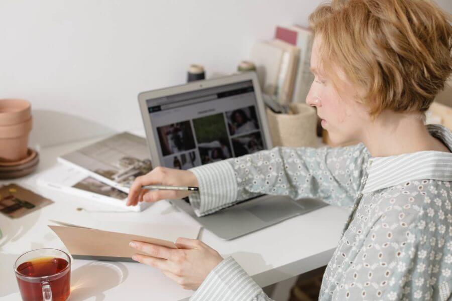 Woman informing herself on a laptop before a move