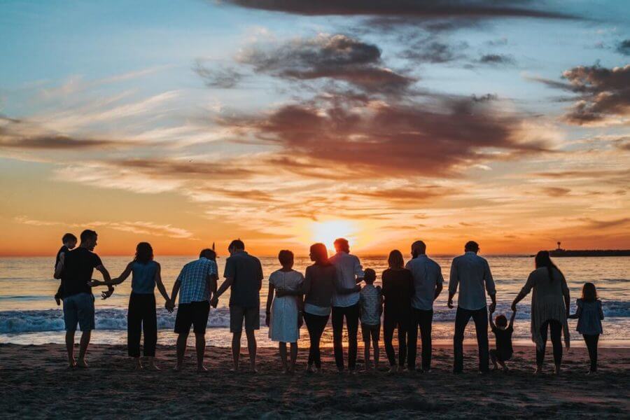Big family watching the sunsets on the beach