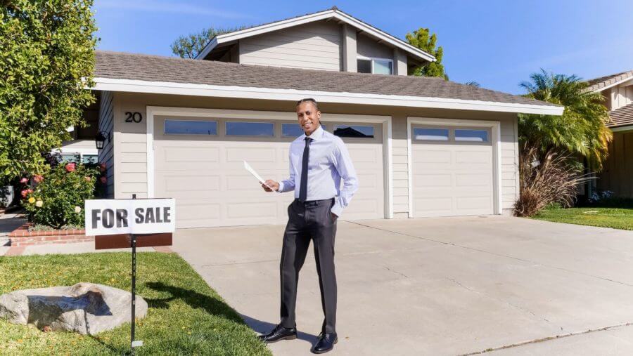 A realtor in front of a house