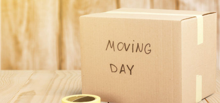 a box ready for moving cross-country with the words 'moving day' written on it