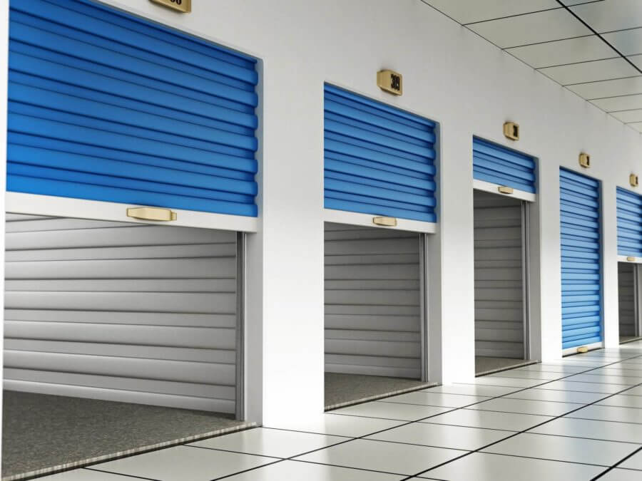 Storage units with closed blue doors getting prepared for customers who are long-distance moving 