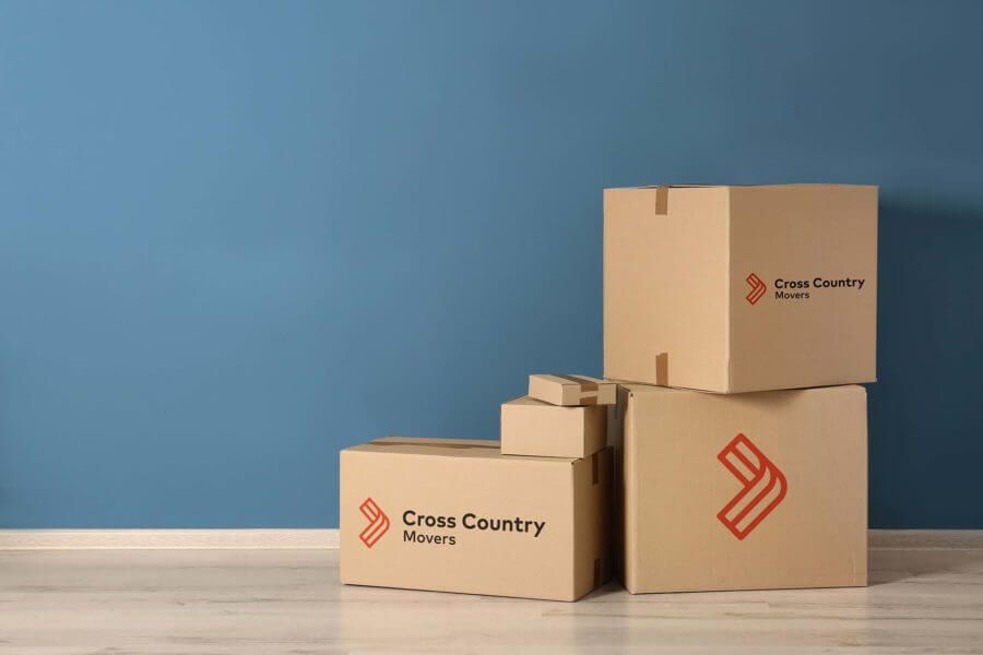 pile of boxes with cross country movers logo