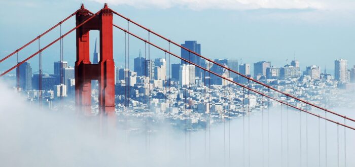 View of The Golden Gate Bridge in fog and San Francisco in the distanc