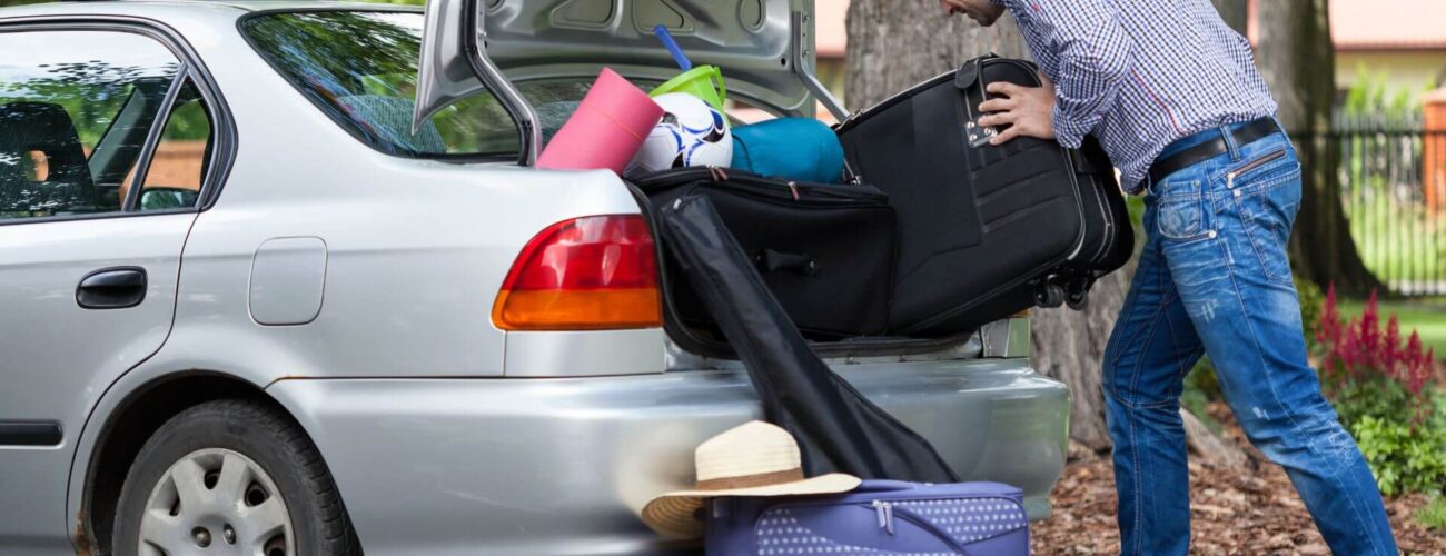 A man packing his stuff in the car