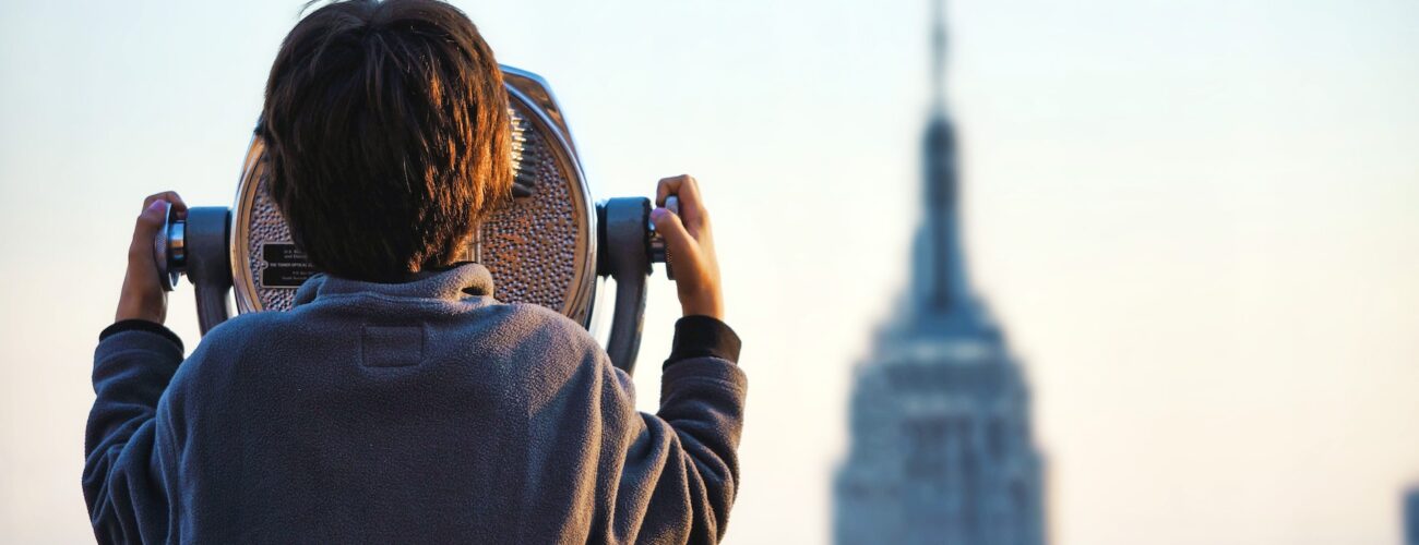 A boy looking at the Empire State Building in New York