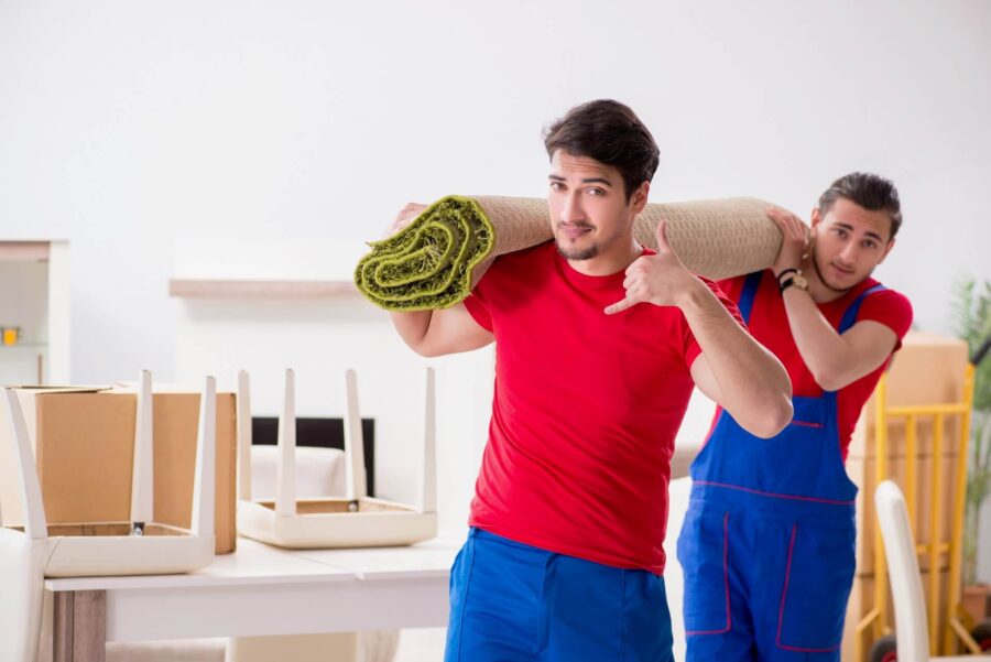 Movers holding a rolled carpet