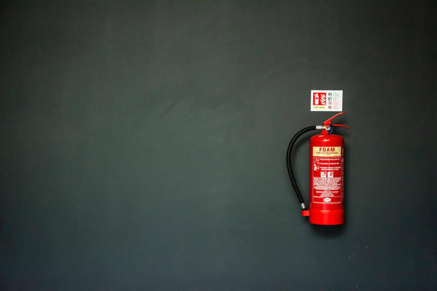 A fire extinguisher placed on the wall 