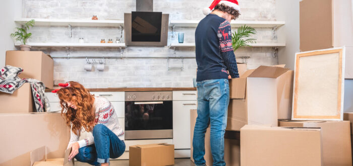 A couple preparing moving boxes during Christmas