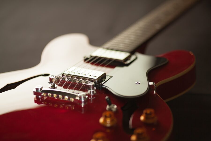 A close-up of a shiny red electric guitar