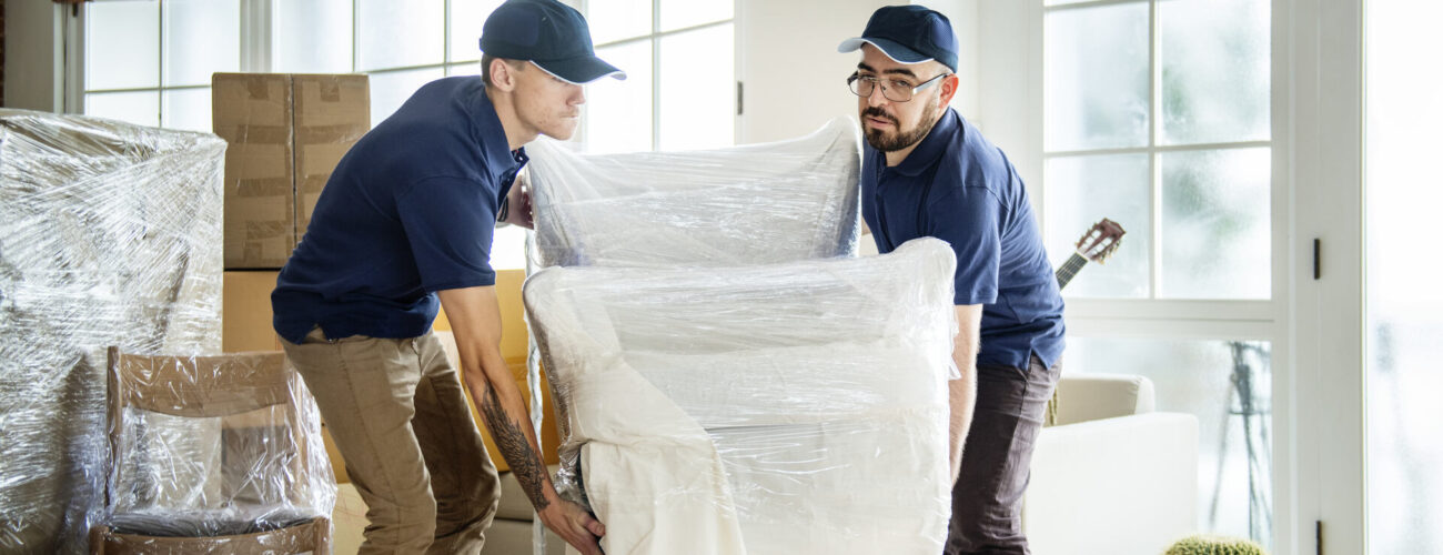 Movers wrapping an armchair