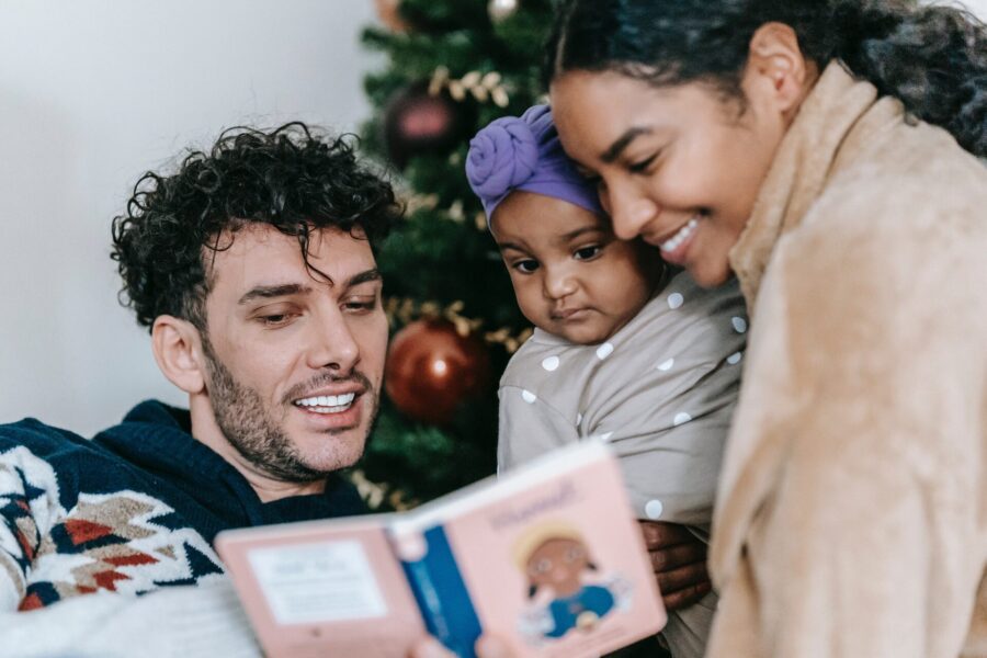 Parents reading a book to a child