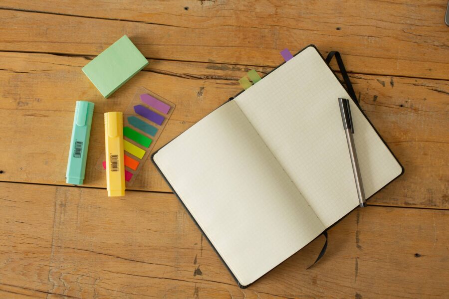 Sticky notes, marker, and notebook on a table