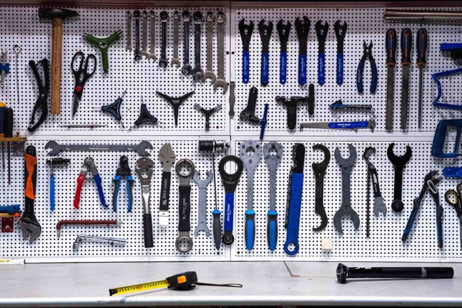 A bunch of tools mounted on the wall 