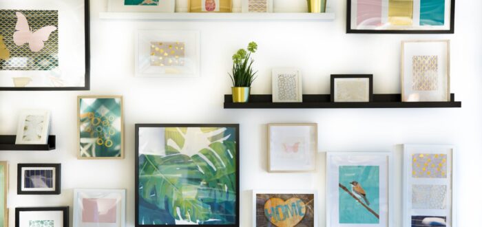 Framed pictures on shelves and wall