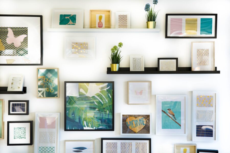 Framed pictures on shelves and wall