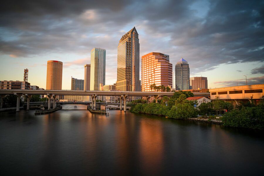 The skyline of Tampa against dark clouds during sunset