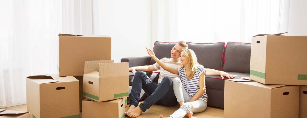 Couple in their new apartment sitting on floor