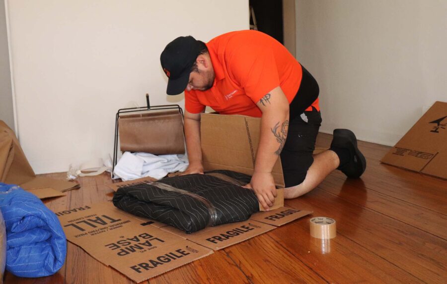 Mover packing items with a blanket