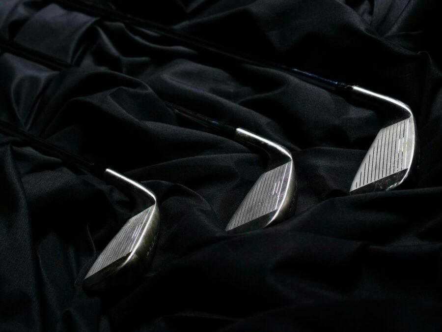 Golf clubs on black fabric