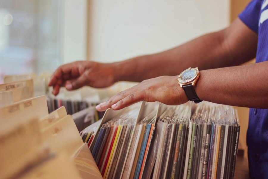 A man browsing vinyl records before long-distance moving