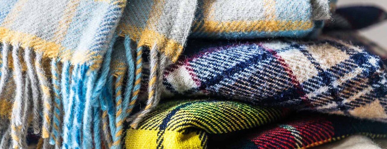 Stack of woolen checked blankets, autumn and winter concept