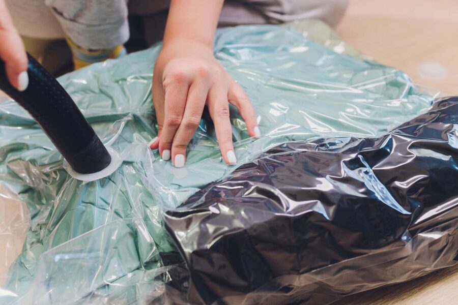 Woman sealing her possessions in the vacuum bag